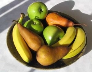 Bowl of fruit including bananas, apples and pears 