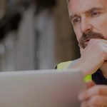 Warehouse manager using a laptop