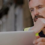 Warehouse manager using a laptop