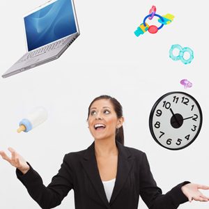 Image of businesswoman juggling a laptop and baby toys