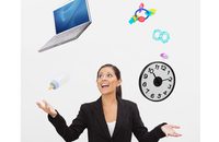 Image of businesswoman juggling a laptop and baby toys