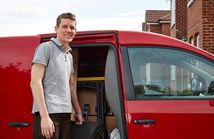 Man standing in front of a red van