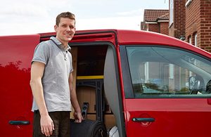 Man standing in front of a red van