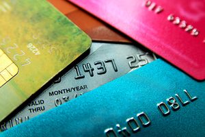 Stack of multicolored credit cards close-up view with selective focus.