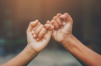 Image of two hands doing a pinky promise