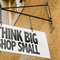A shop sign saying "Think big, shop small"