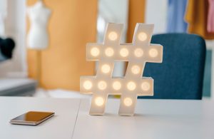 Image of a hashtag sign light on a desk