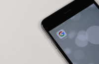 Image of mobile phone with Google app icon on screen