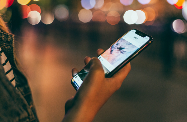 Girl holding a phone, using an app